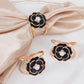 Black pearl floral metal chair sash bow pins with gold rim.
