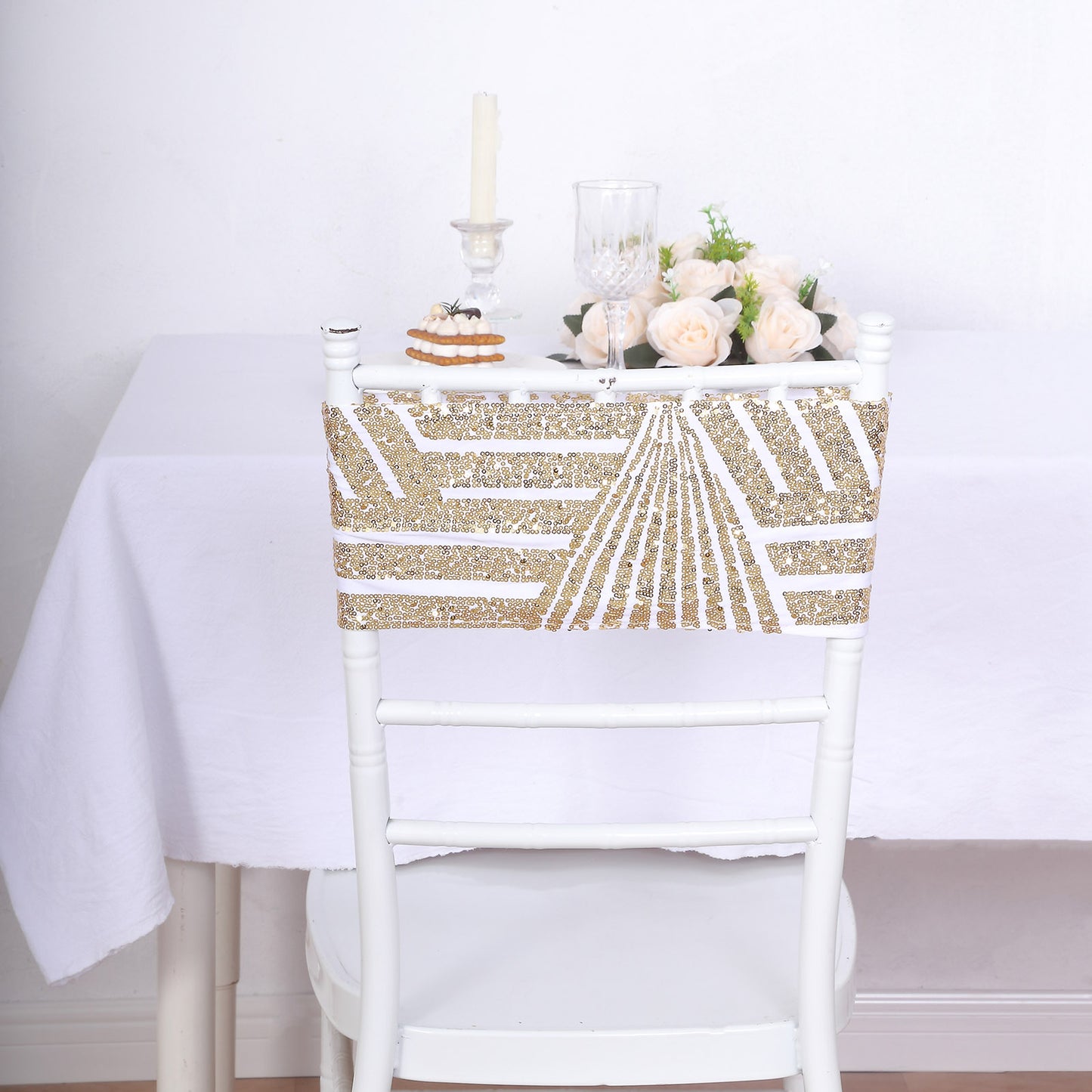 Gold sequin chair sash with geometric design on a white chair.