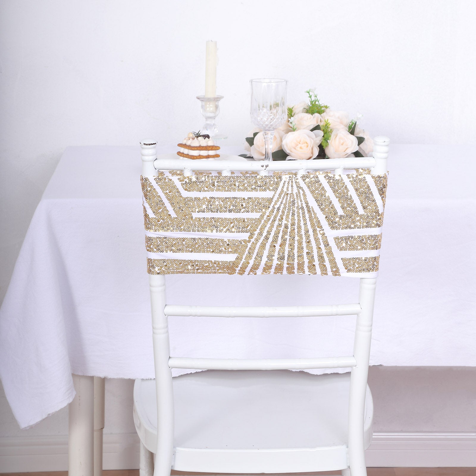 Gold sequin chair sash with geometric design on a white chair.