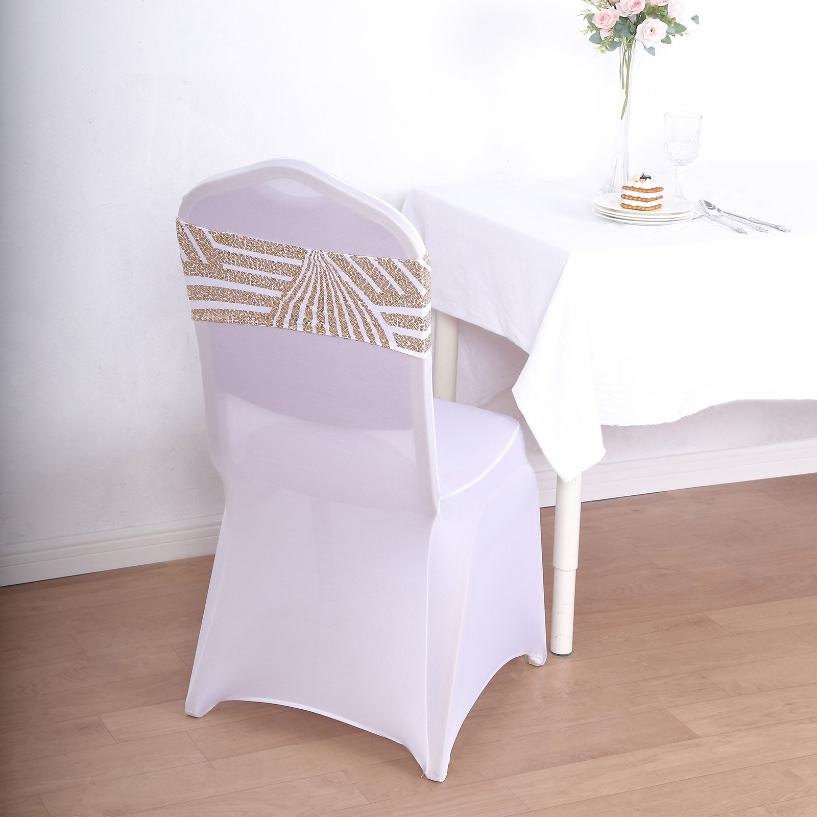 Gold sequin white spandex chair sash on a dining chair.