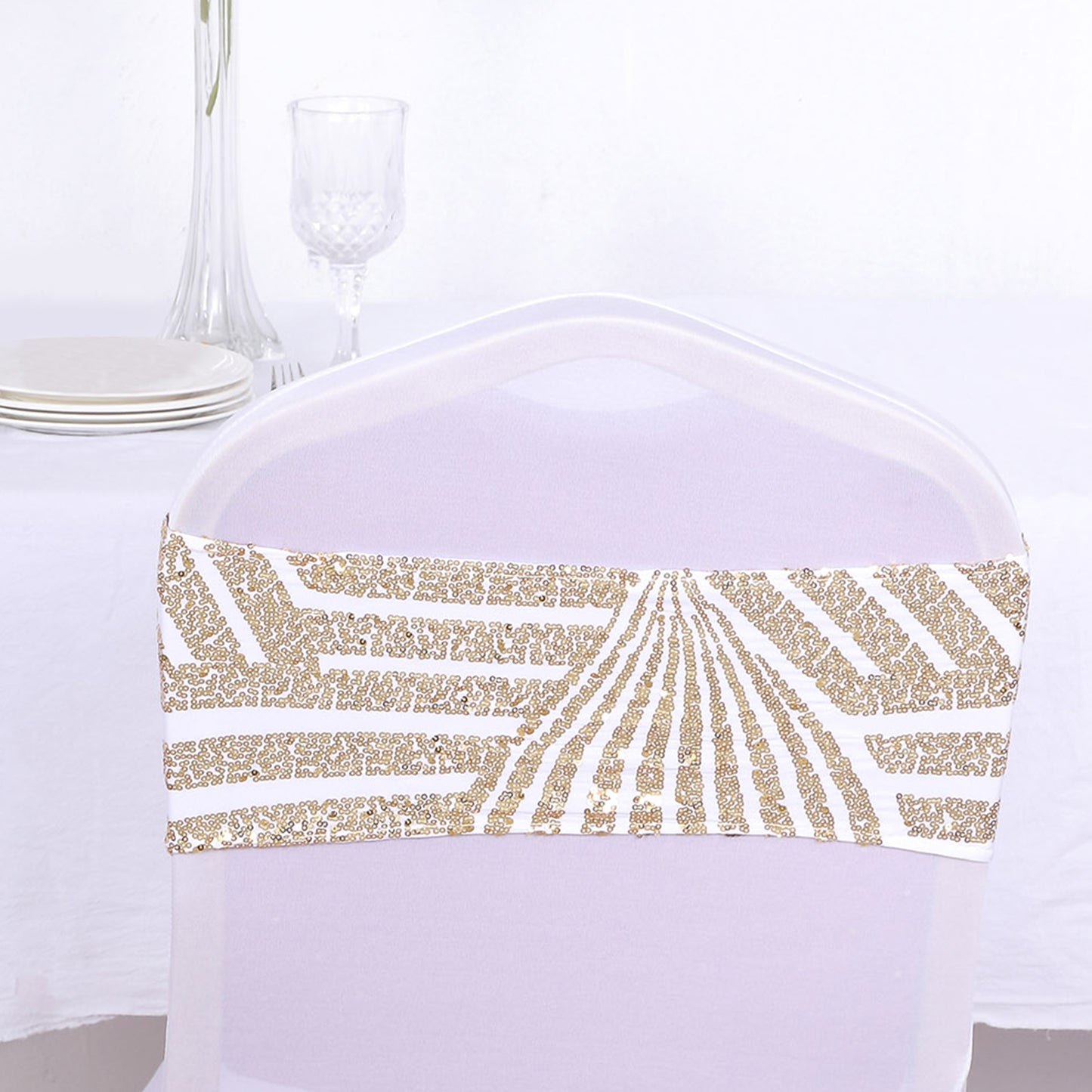 Gold sequin chair sash band on a white chair.