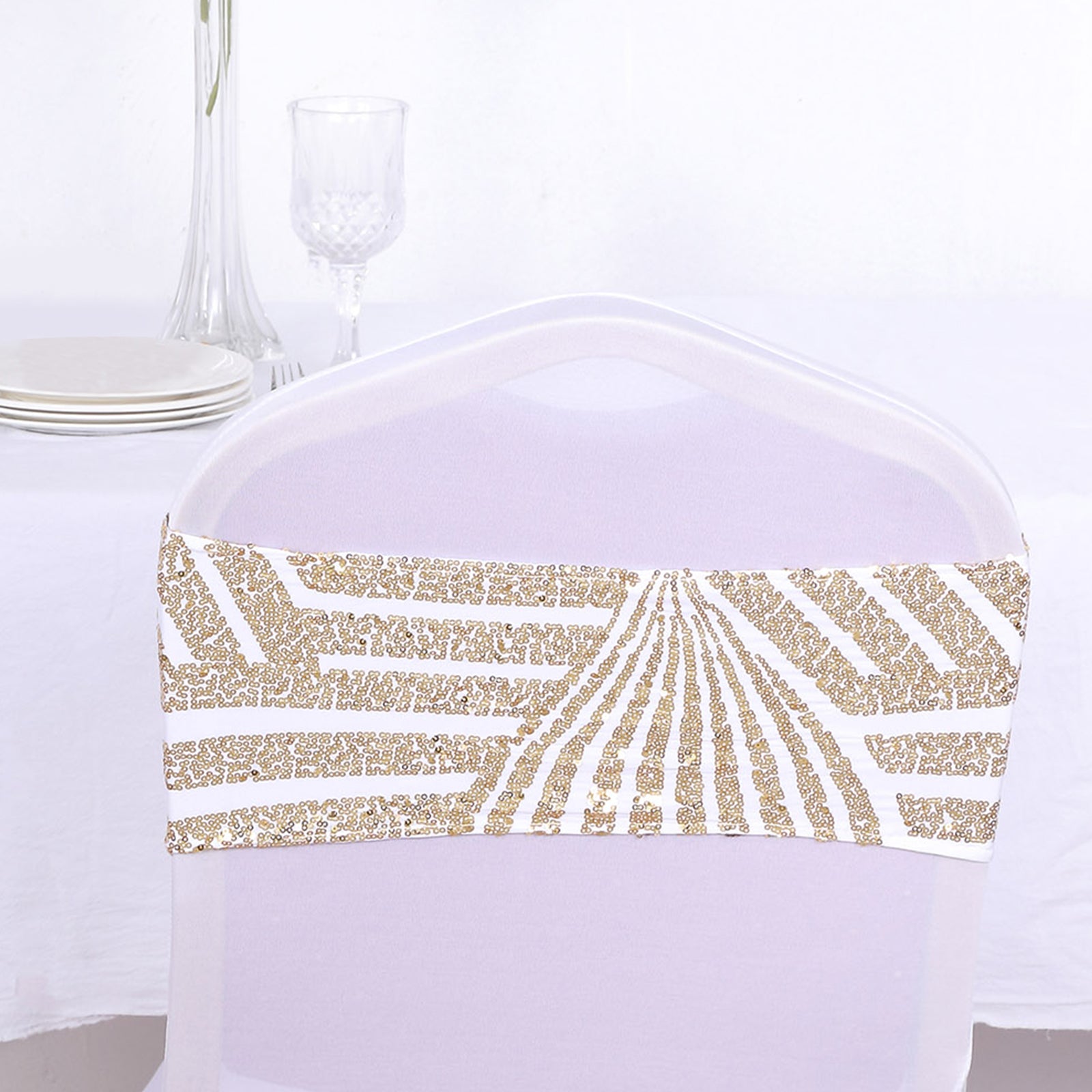 Gold sequin chair sash band on a white chair.