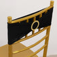 Black spandex chair sash with gold diamond buckle on a golden chair.