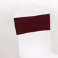 Burgundy spandex chair sash with gold diamond buckle on white chair.