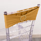 Gold spandex chair sash with diamond buckle on a clear chair.