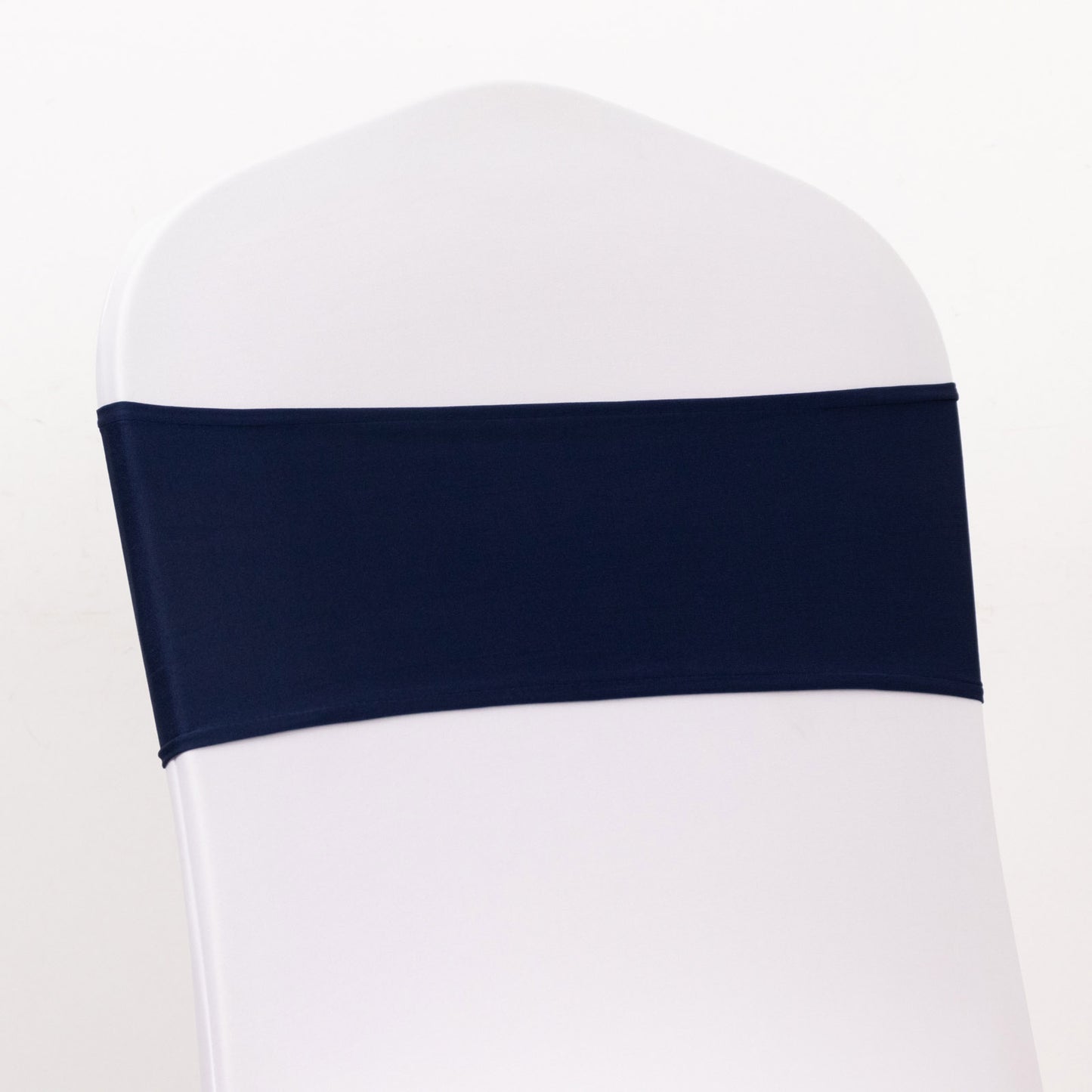 Navy blue spandex chair sash on a white chair.
