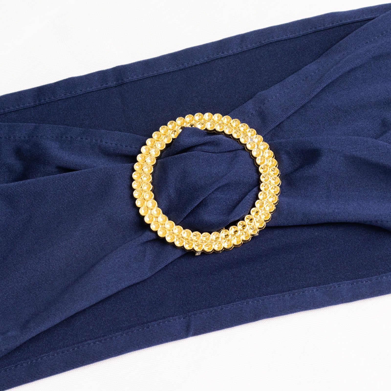 Navy blue spandex chair sash with gold diamond buckle. #whtbkgd