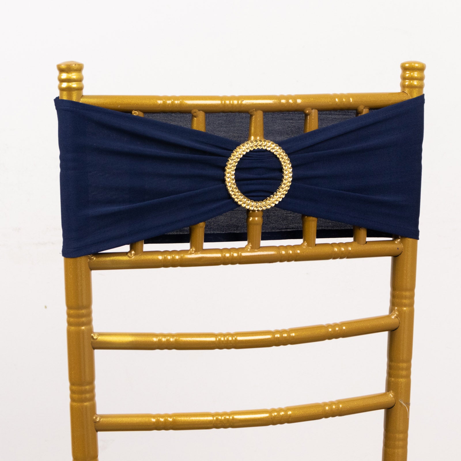 Navy blue spandex chair sash with gold diamond buckle on a golden chair.