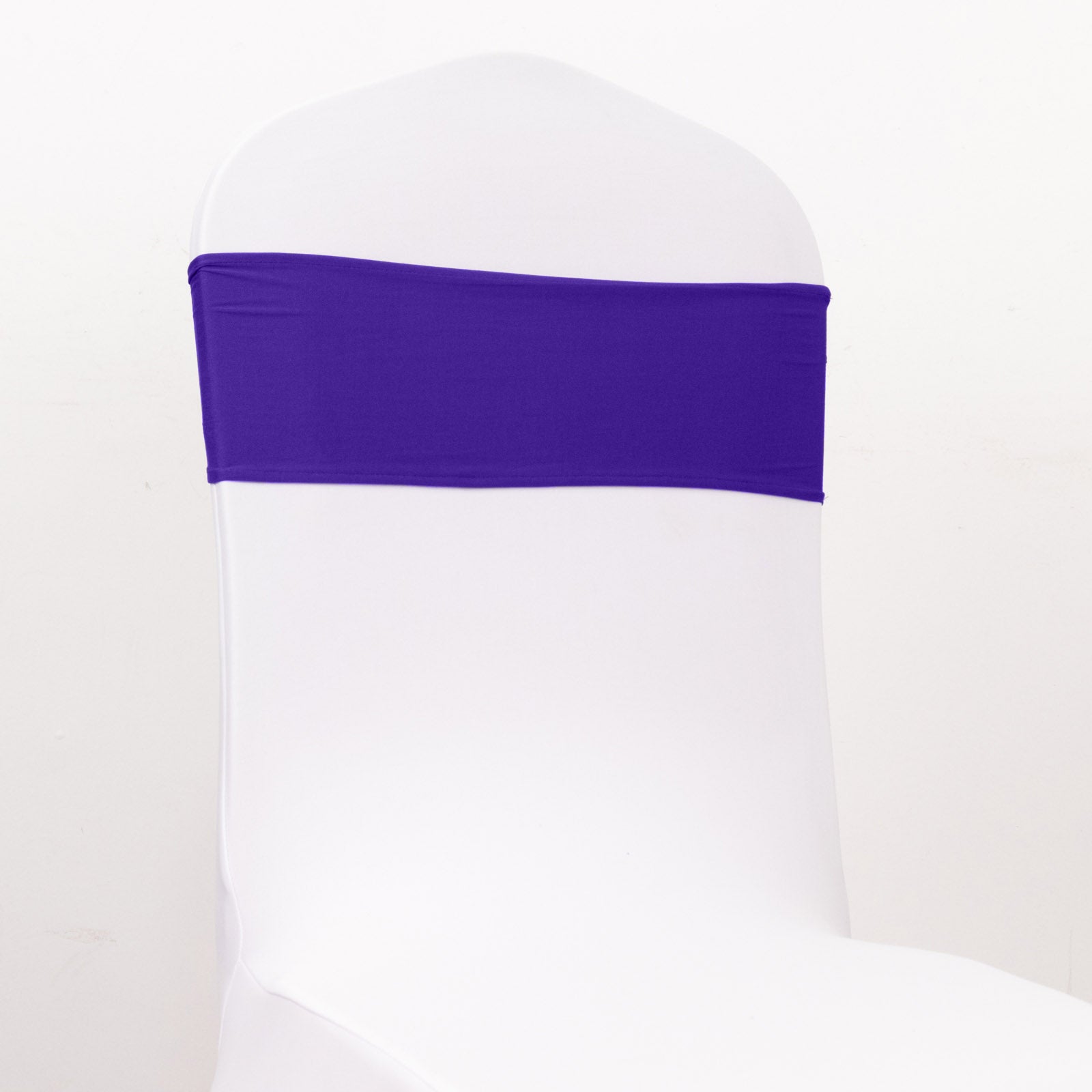 Purple spandex chair sash with gold diamond buckle on a white chair.