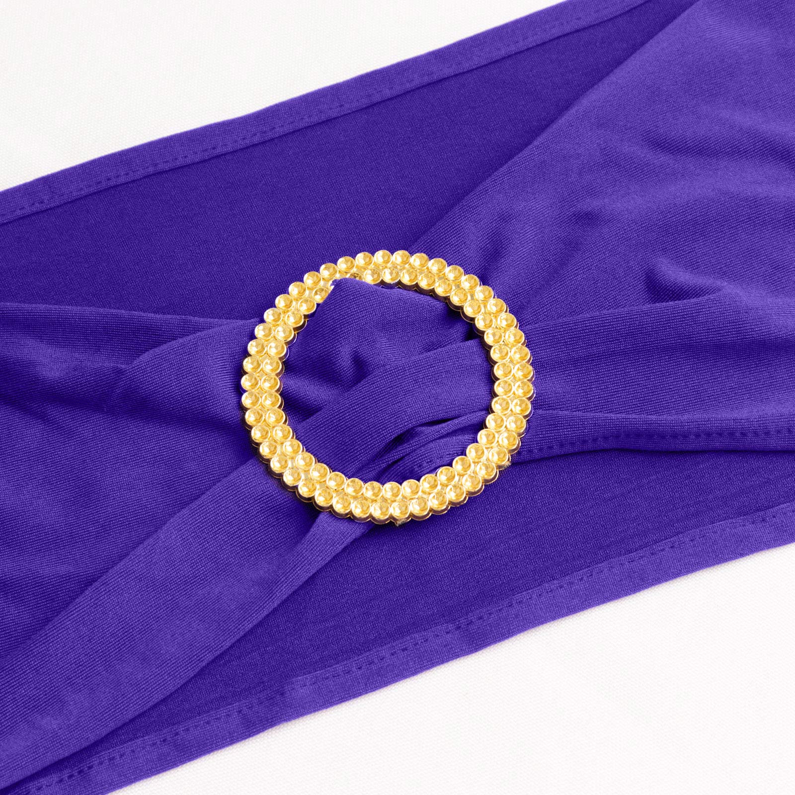 Purple spandex chair sash with gold diamond buckle, elegant and stretchy design. #whtbkgd