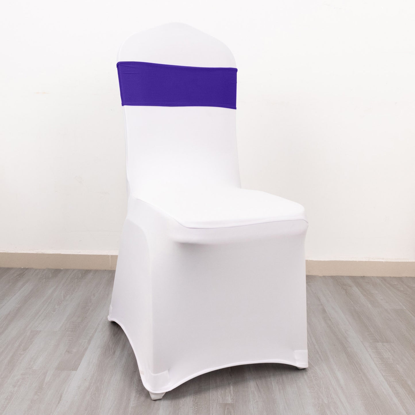 Purple spandex chair sash with gold buckle on a white chair.