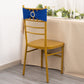 Royal blue spandex chair sash with gold diamond buckle on a gold chair.