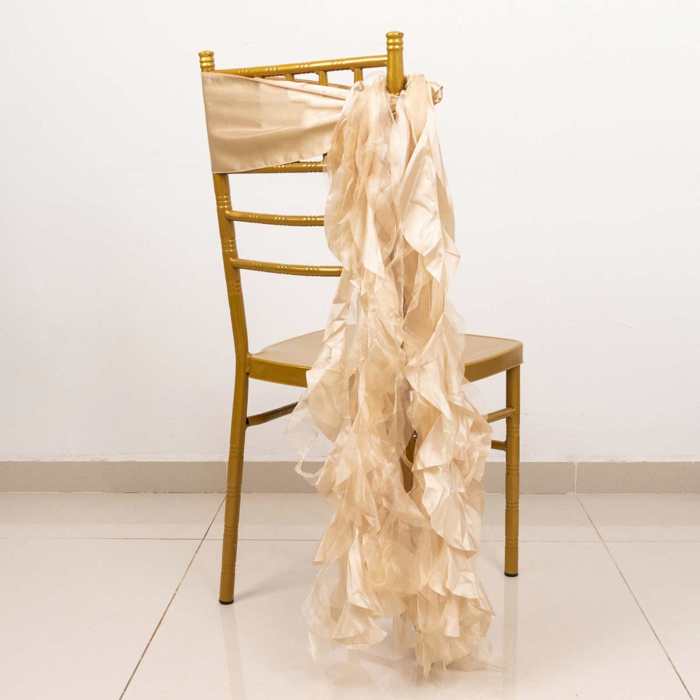 Beige curly willow chiffon satin chair sash on a gold chair