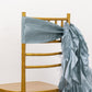 Dusty blue chiffon satin chair sash on a gold chair.