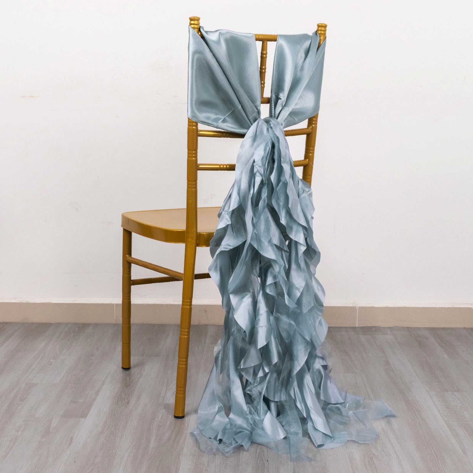 Dusty blue chiffon satin chair sash draped on a gold chair.