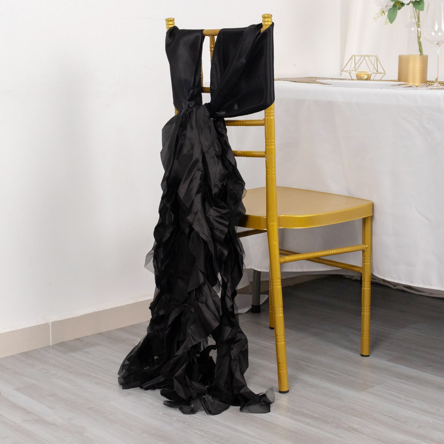 Black chiffon satin chair sashes elegantly draping a chair.