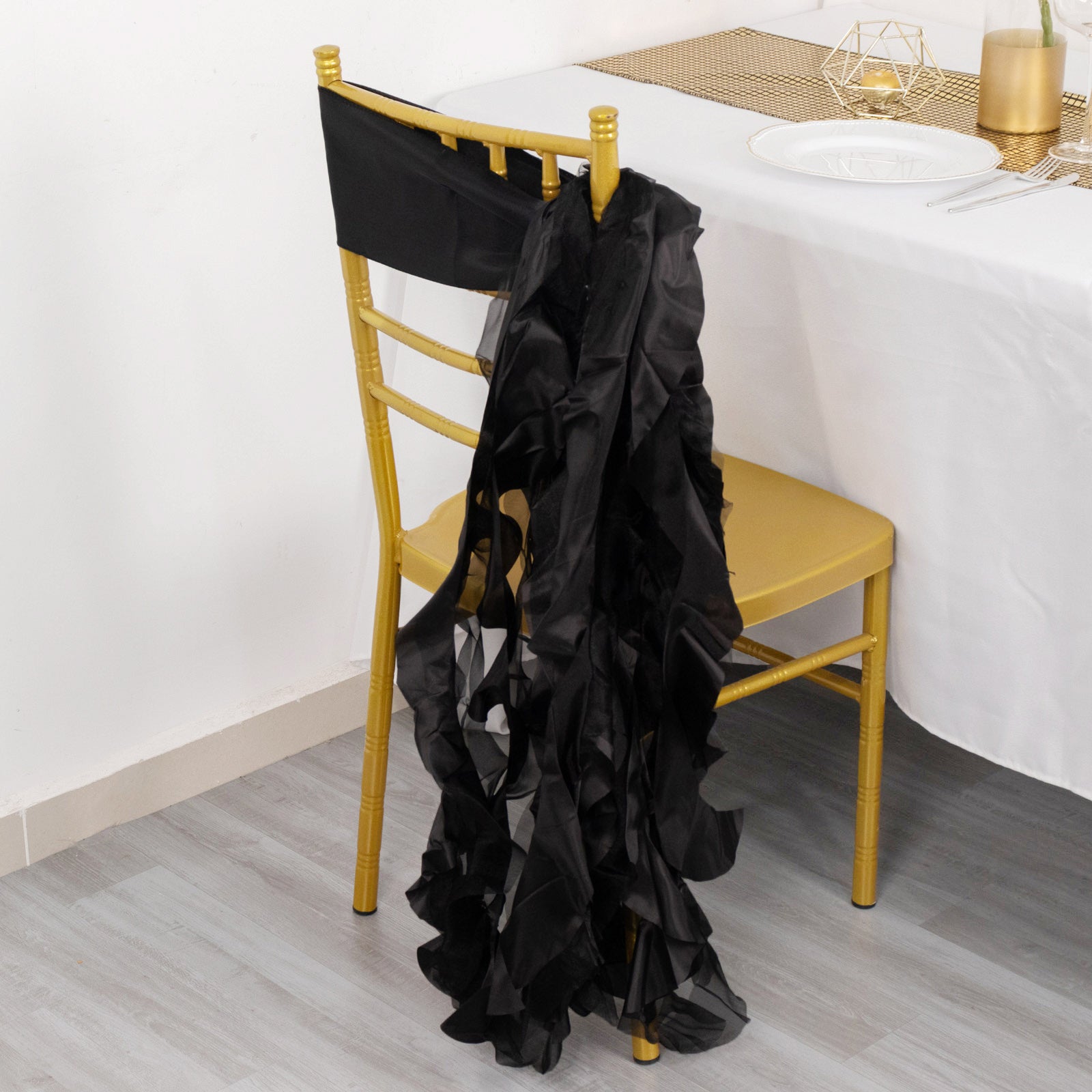 Black curly willow chiffon satin chair sash on a gold chair.