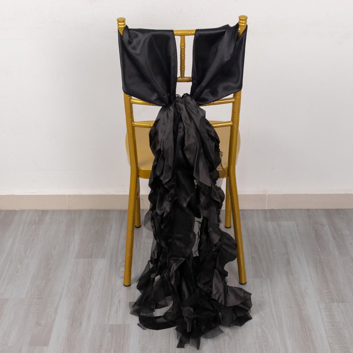 Black curly chiffon satin chair sashes on a gold chair.