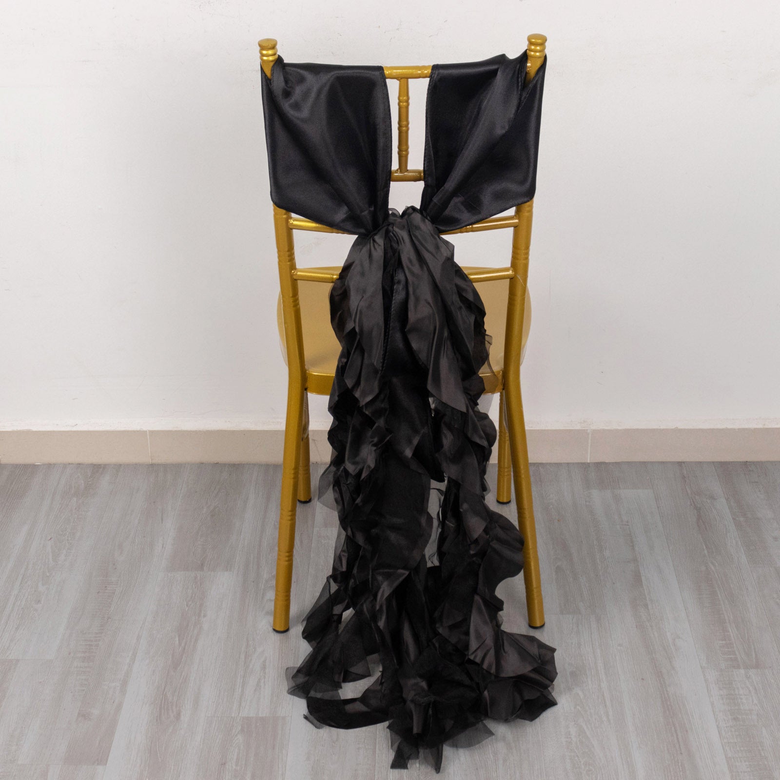 Black curly chiffon satin chair sashes on a gold chair.