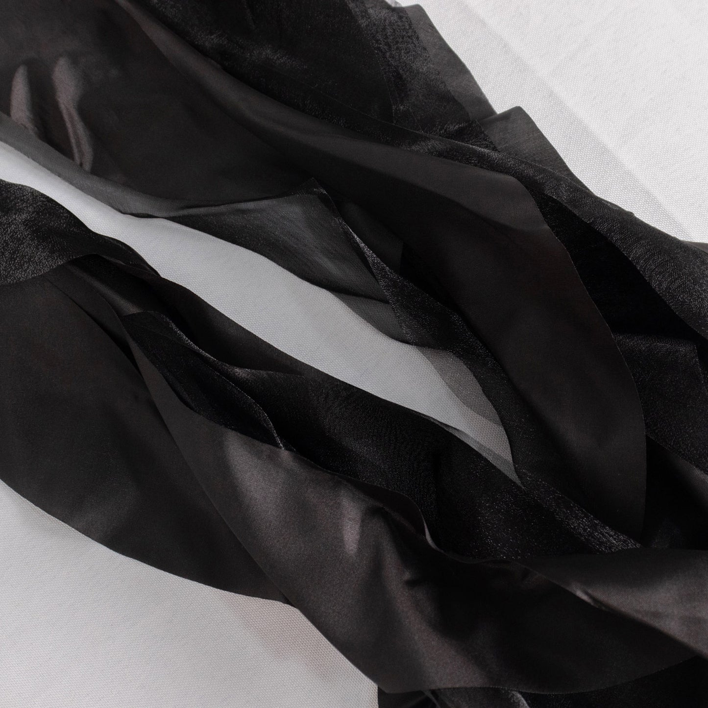 Black chiffon satin chair sashes, perfect for elegant events.