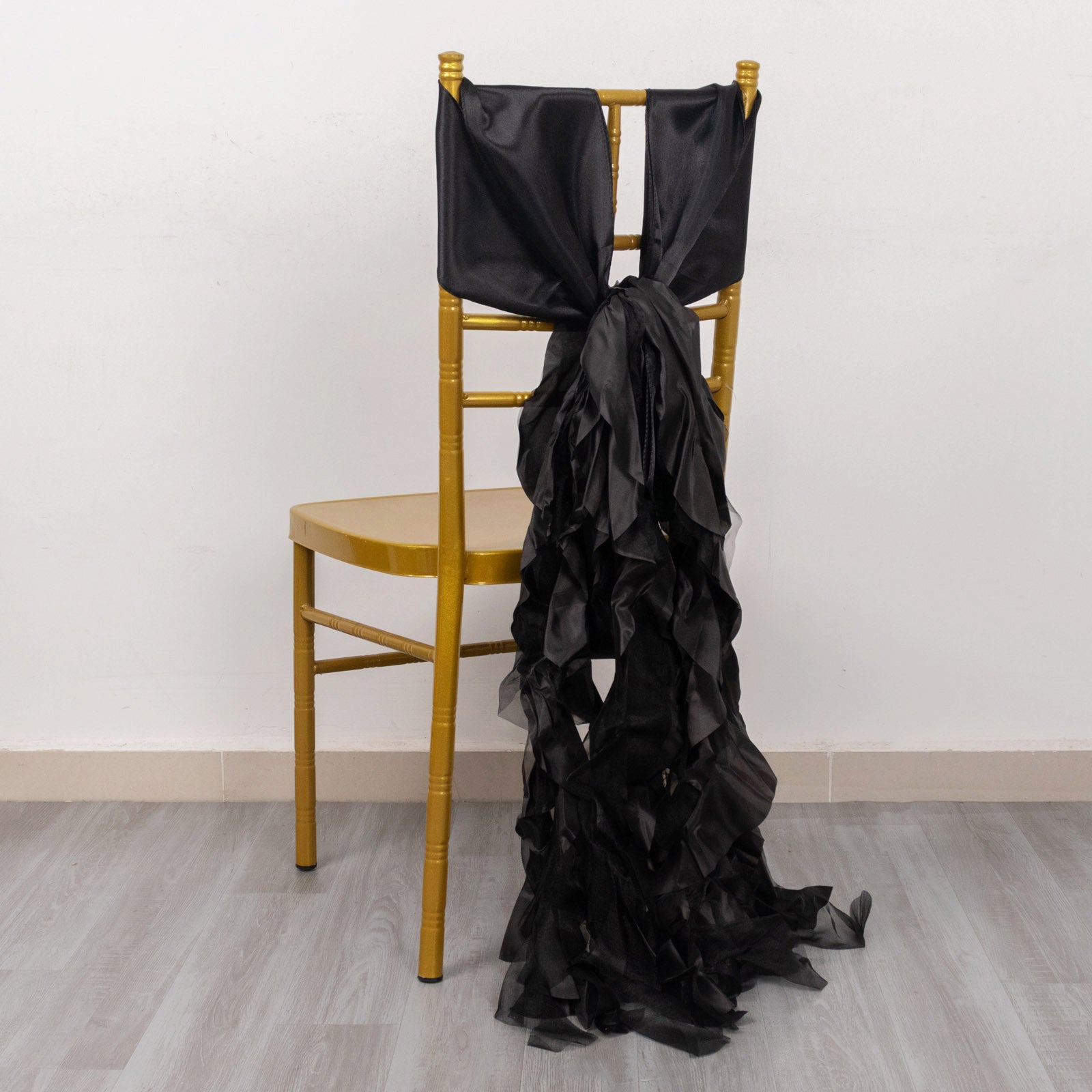 Black curly willow chiffon satin chair sashes on a gold chair.