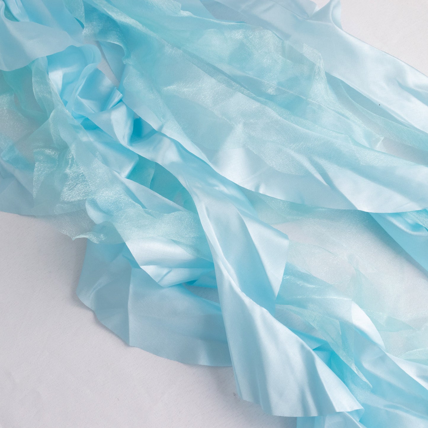 Light blue chiffon satin chair sashes, perfect for elegant events.