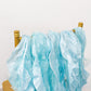 Light blue curly chiffon satin chair sashes on a gold chair.