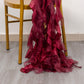 Burgundy chiffon satin chair sashes draping from a chair.