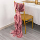 Cinnamon rose chiffon satin chair sash tied on a gold chair.