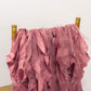 Cinnamon rose chiffon satin chair sashes draped on a gold chair.