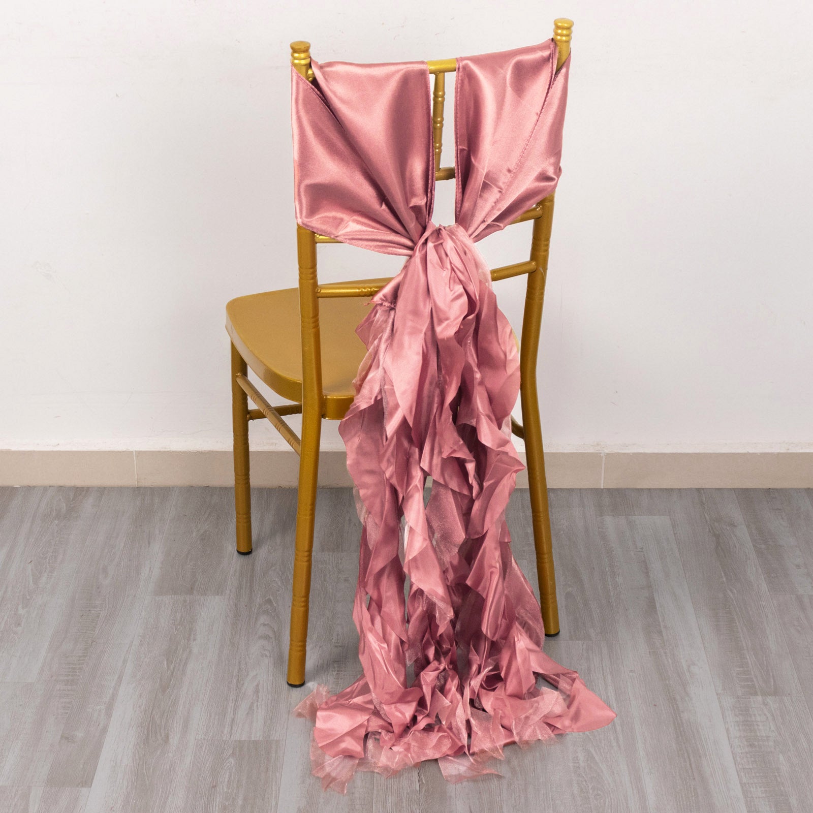 Cinnamon rose curly willow chiffon satin chair sash on a gold chair.