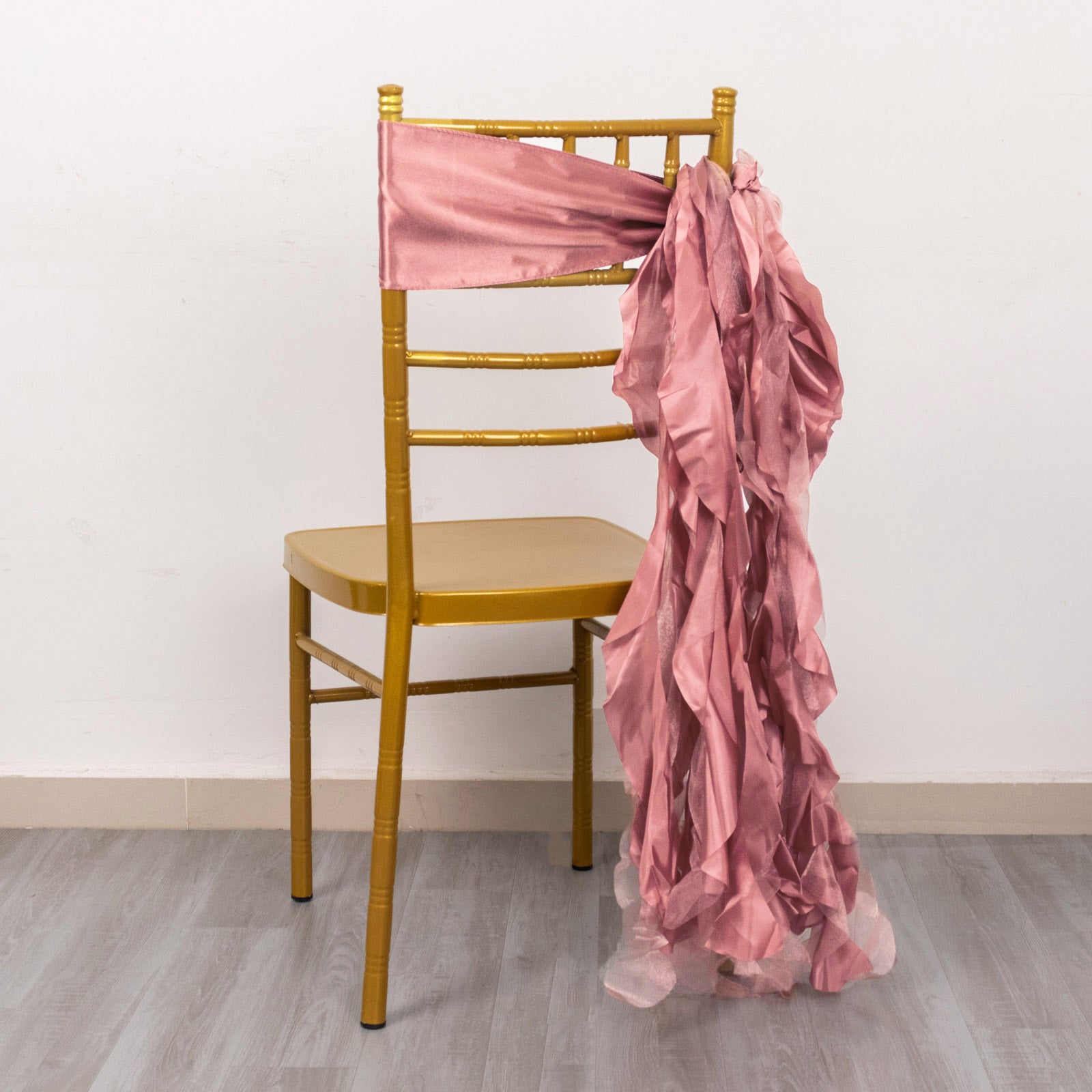 Cinnamon rose curly willow chiffon satin chair sash on a gold chair.