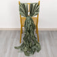 Dusty sage green curly chiffon satin chair sash on a chair.