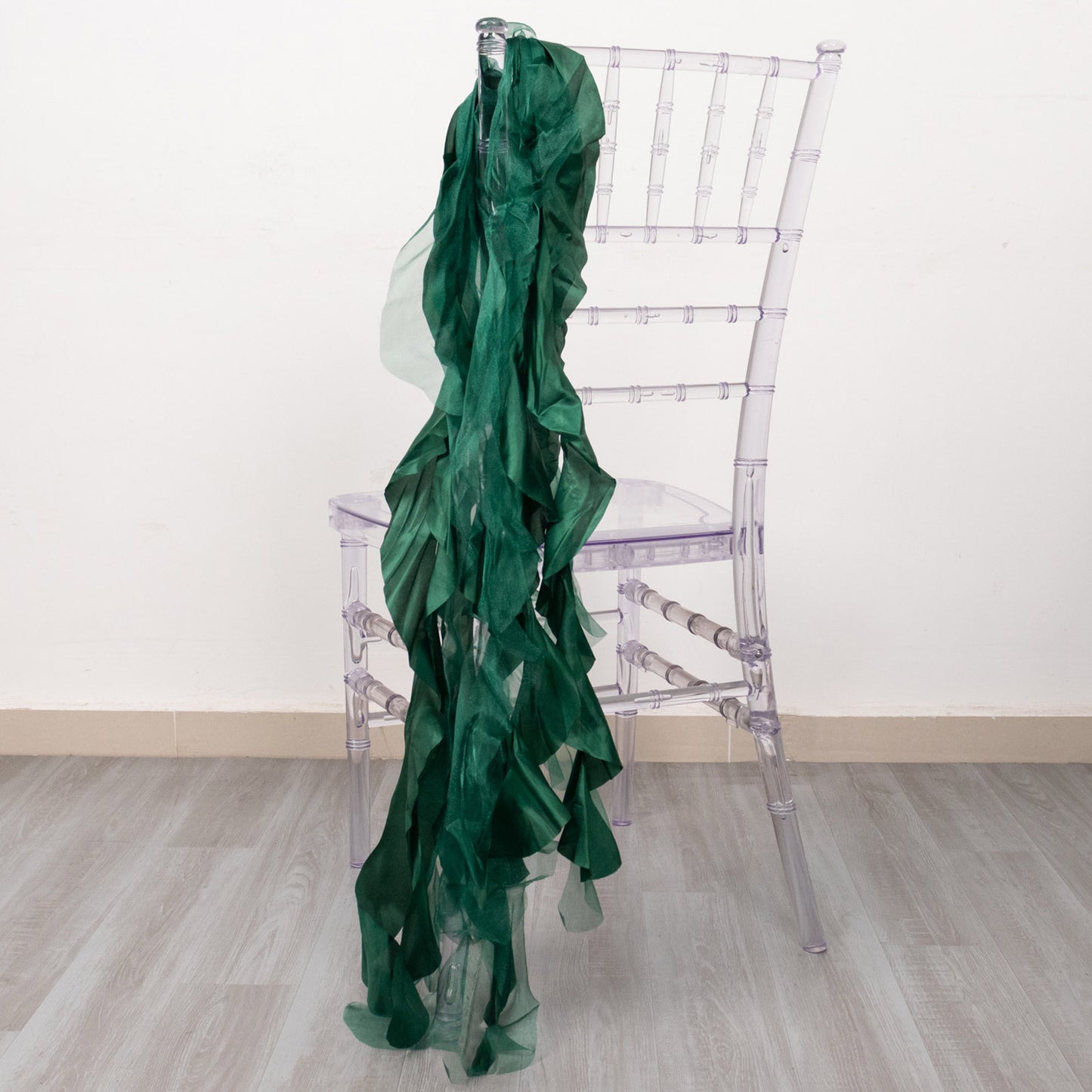 Hunter emerald green chiffon satin chair sash on a clear chiavari chair.