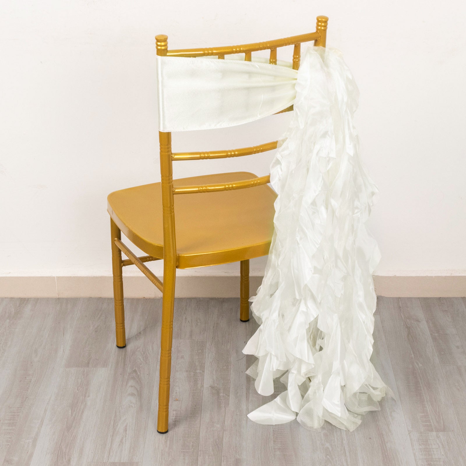 Ivory curly willow chiffon satin chair sash on a gold chair