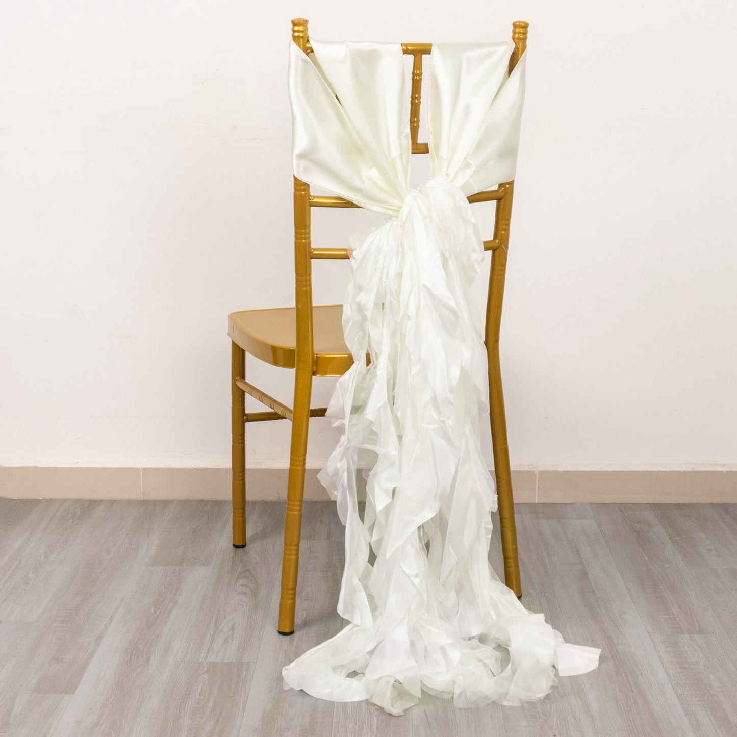 Ivory curly willow chiffon satin chair sash on a gold chair.