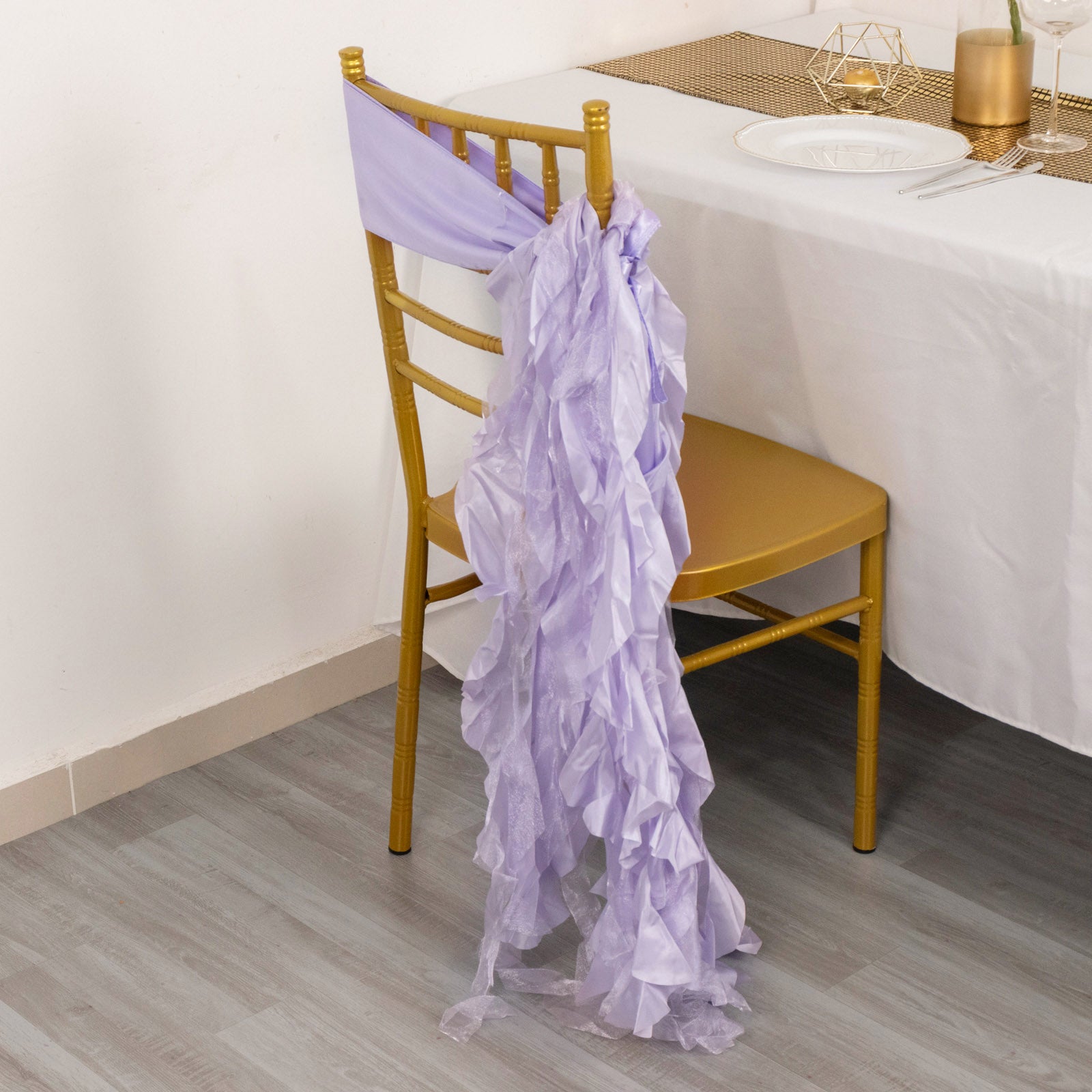 Lavender lilac chiffon satin chair sash draped over a gold chair.