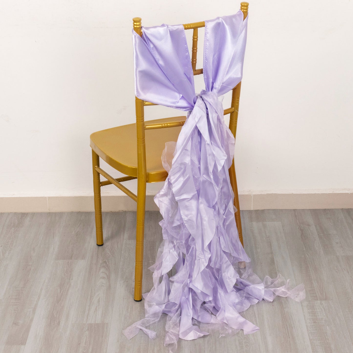Lavender lilac chiffon satin chair sash draped on a gold chair.