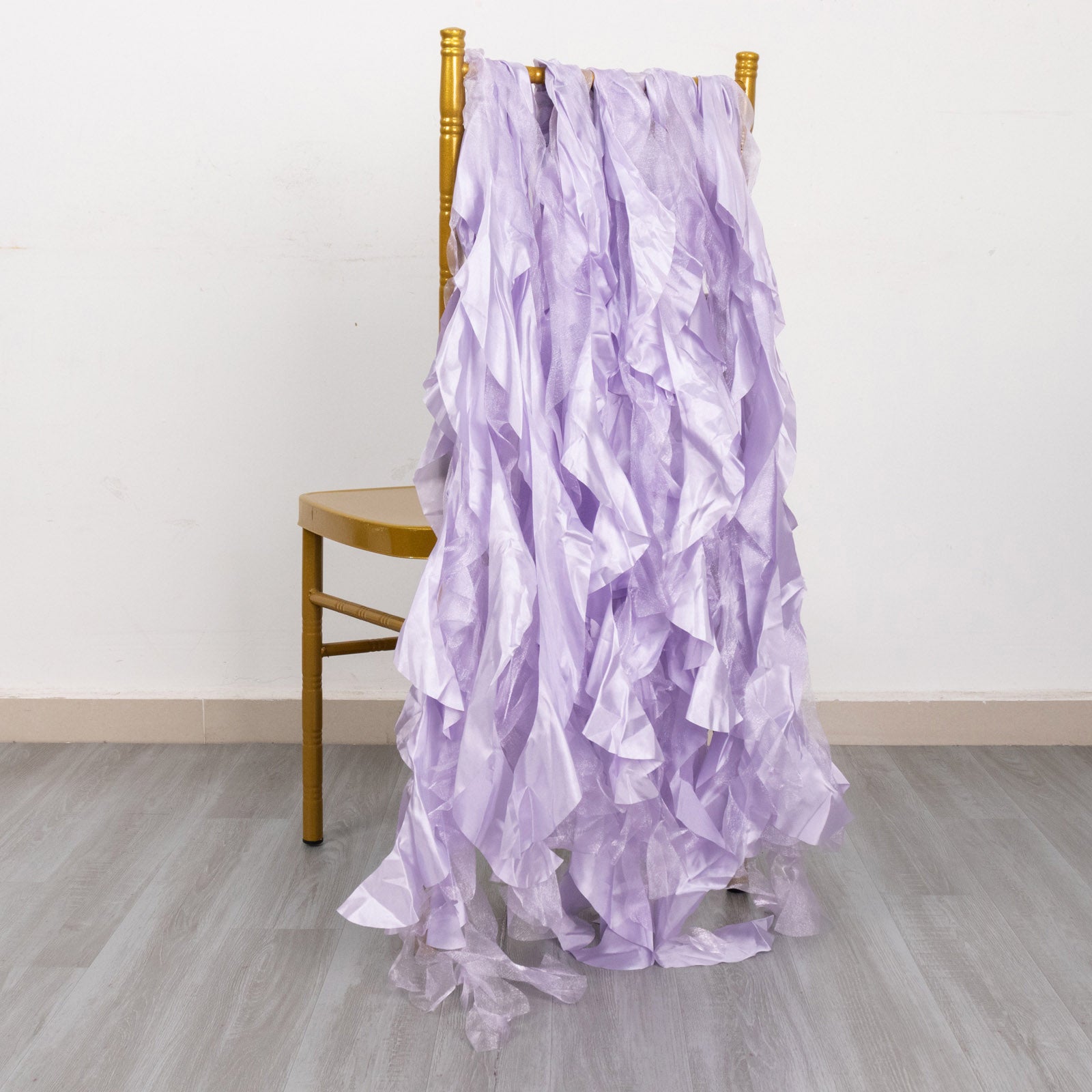 Lavender lilac chiffon satin chair sashes displayed on a gold chair.