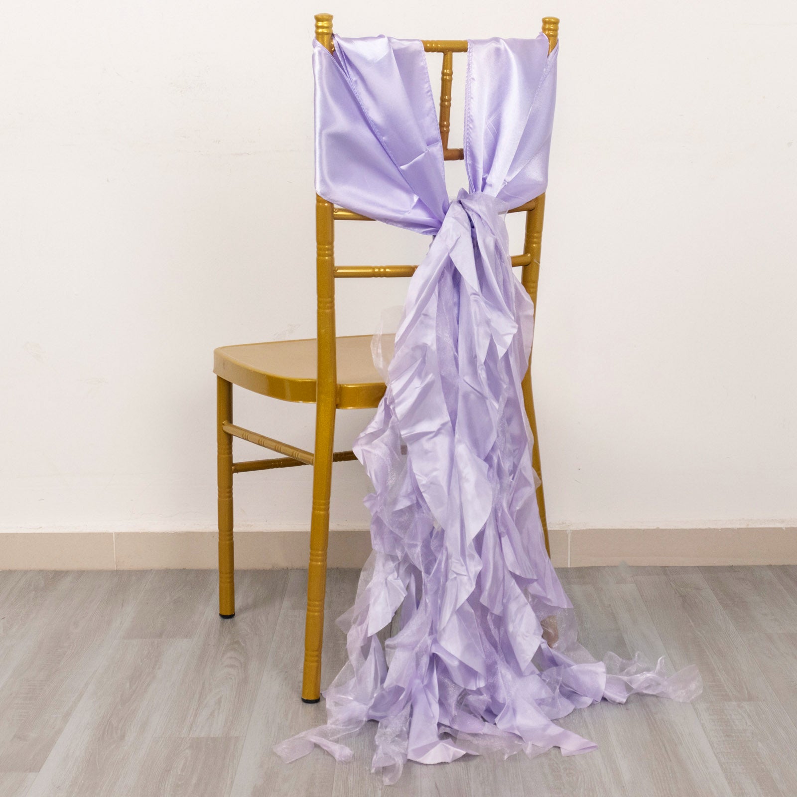 Lavender lilac chiffon satin chair sash draped on a gold chair.