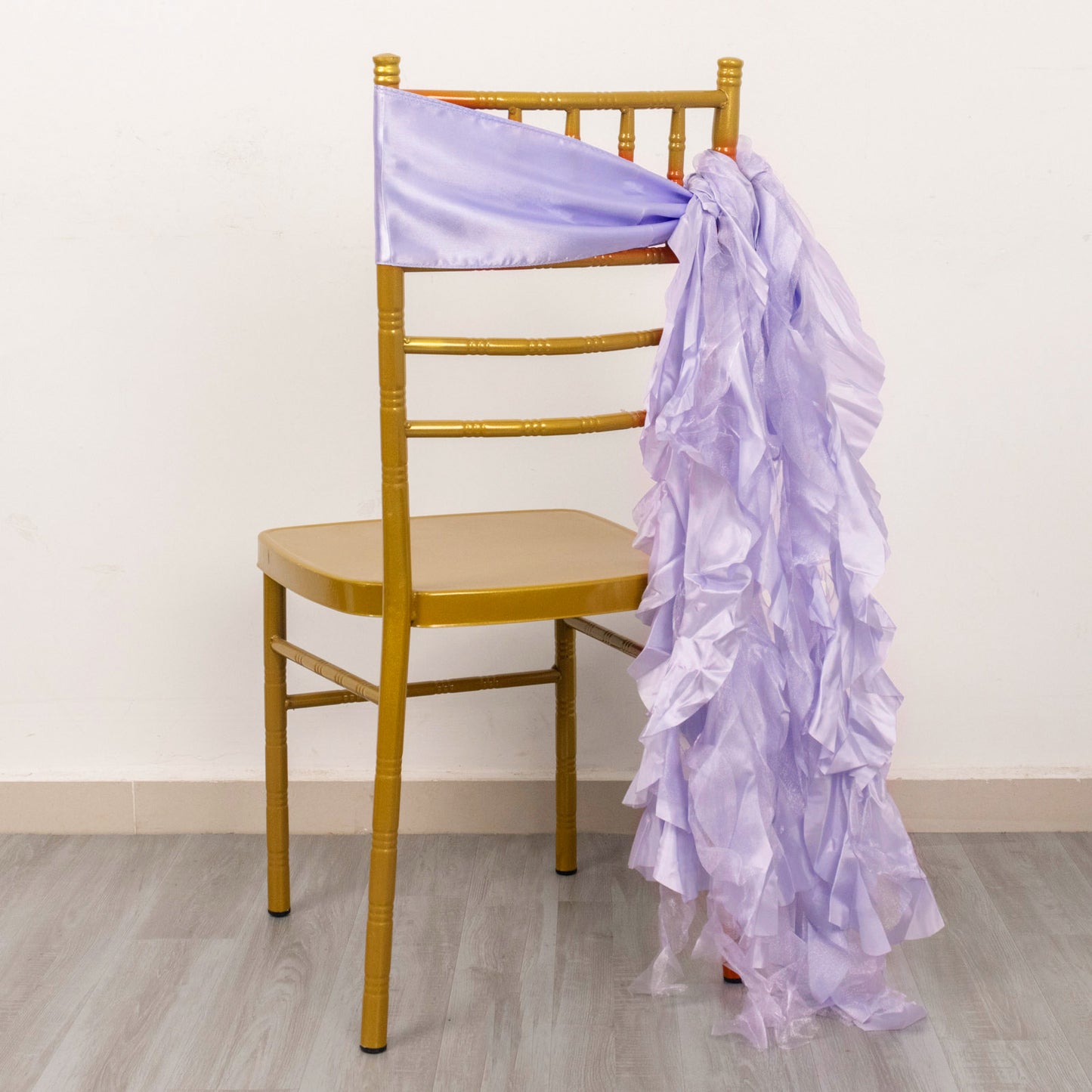 Lavender lilac chiffon satin chair sash draped on a gold chair.