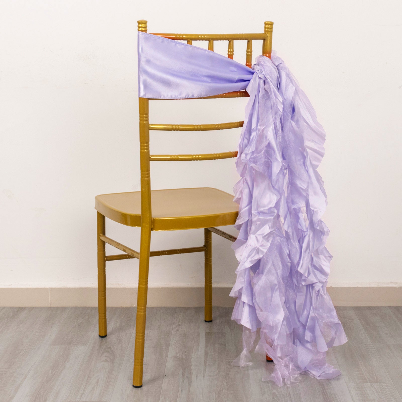 Lavender lilac chiffon satin chair sash draped on a gold chair.