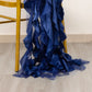 Navy blue curly chiffon satin chair sashes draped on a chair leg.