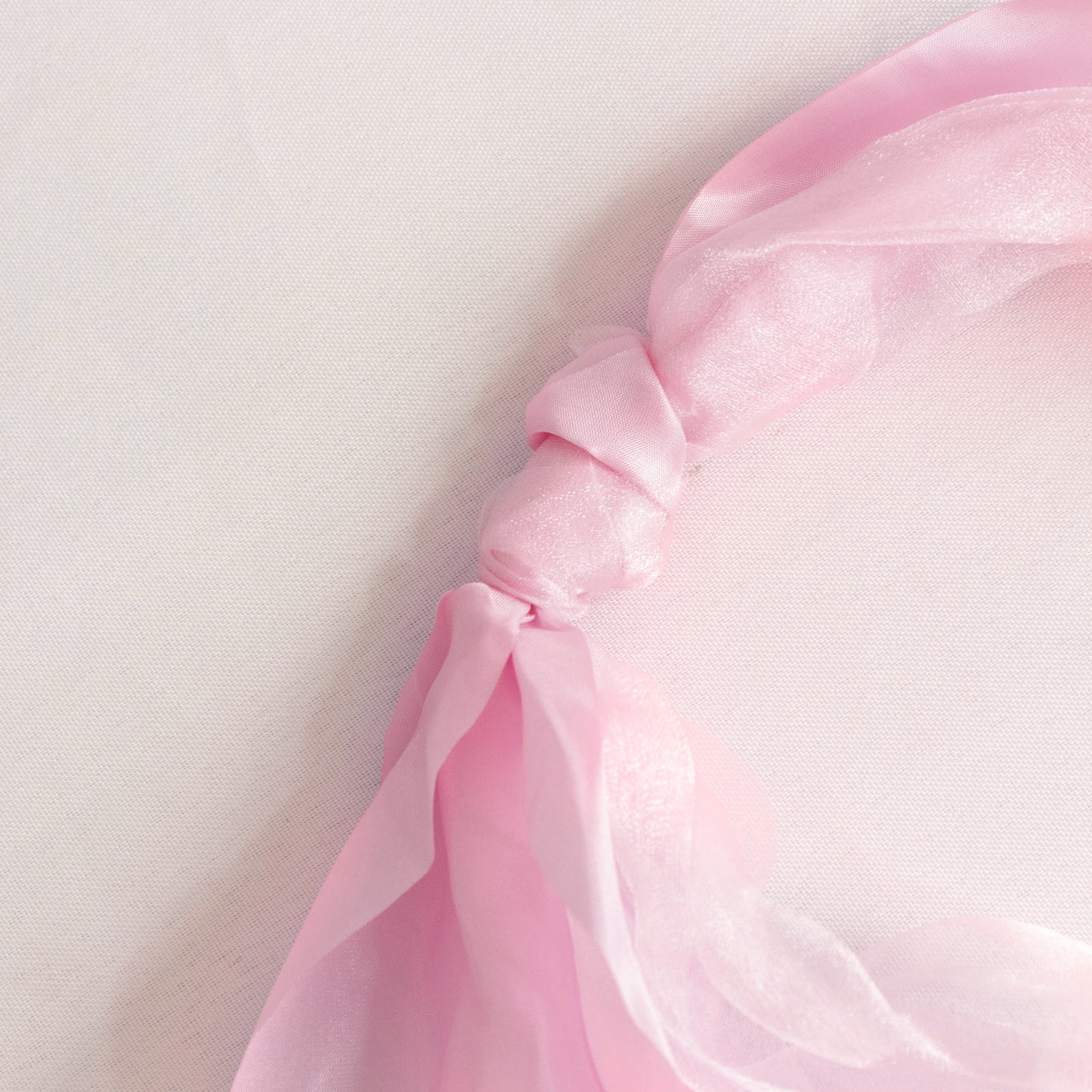 Pink chiffon satin chair sash tied elegantly.