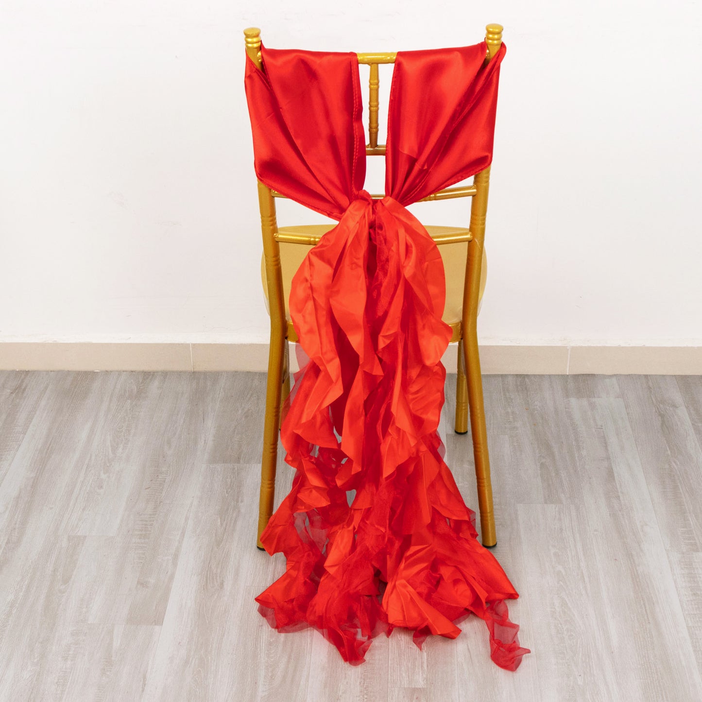 Red curly willow chiffon satin chair sashes on a gold chair.