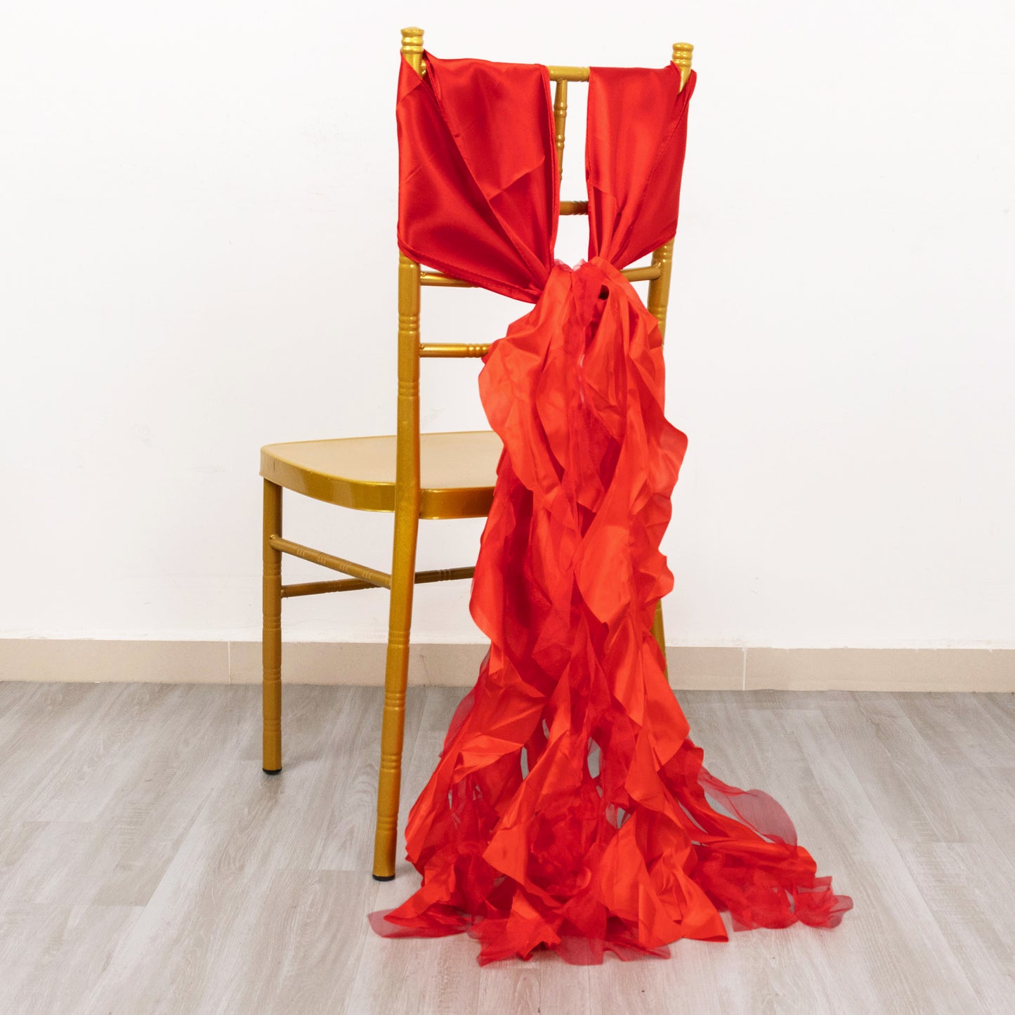 Red curly willow chiffon satin chair sashes draped on a gold chair.