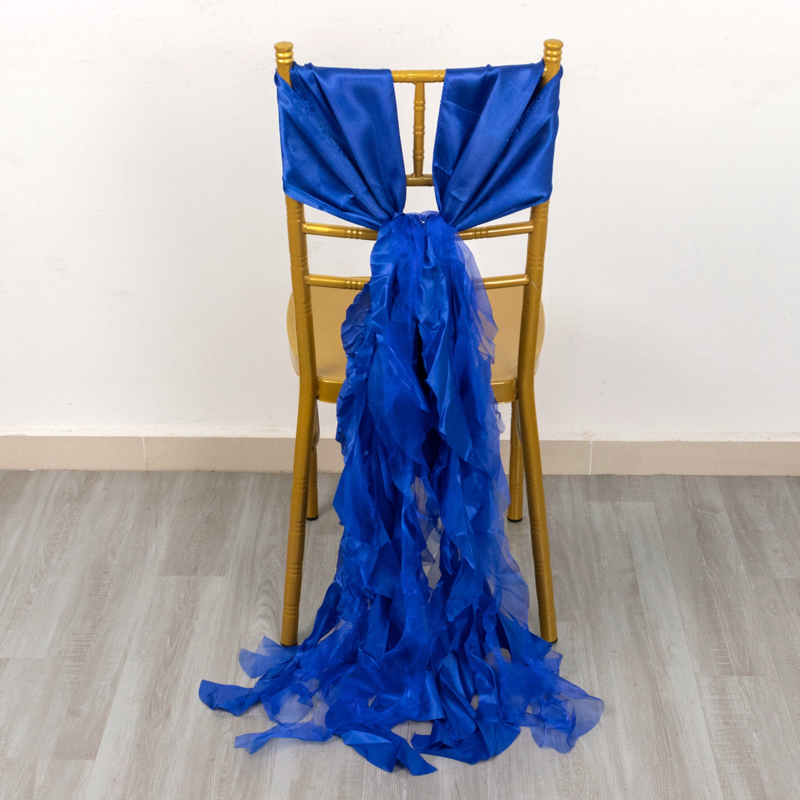 Royal blue chiffon satin chair sashes elegantly draped on a chair.