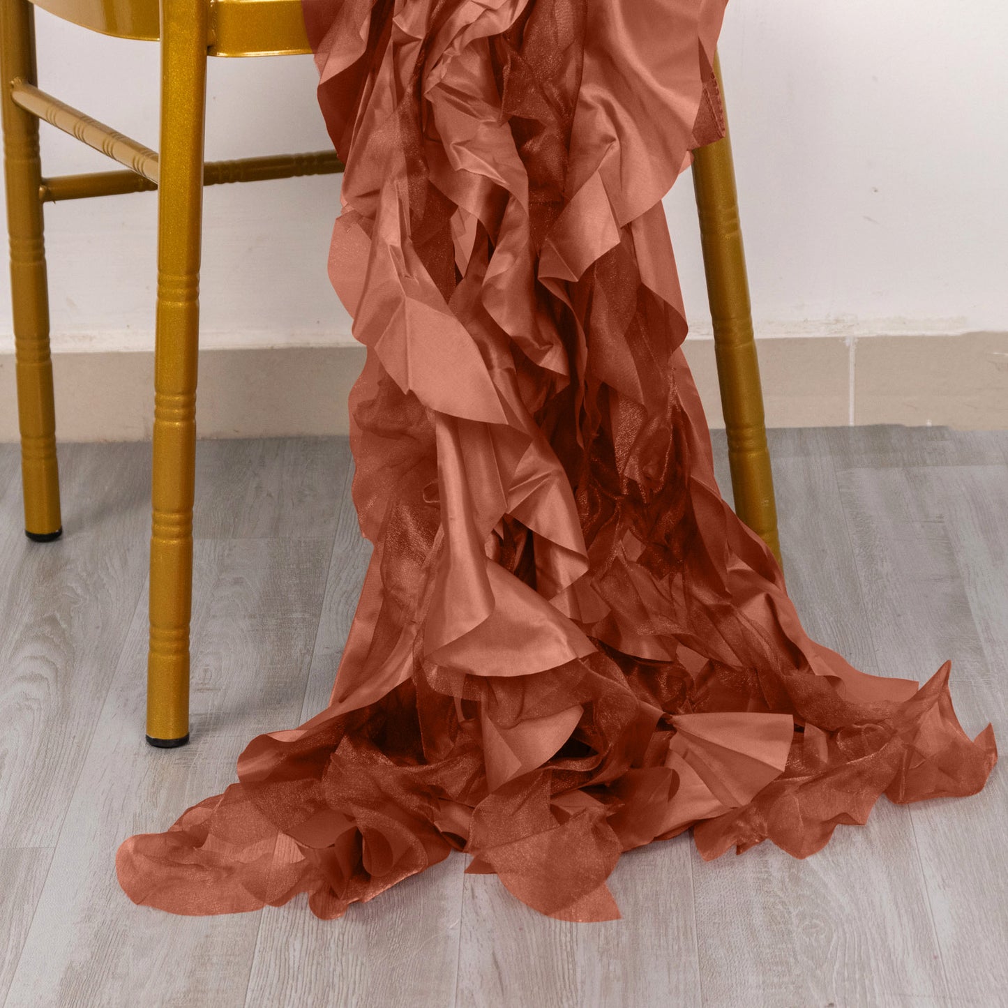 Terracotta curly willow chiffon satin chair sashes draped on a chair.