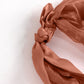 Terracotta chiffon satin chair sash with a curly willow design.