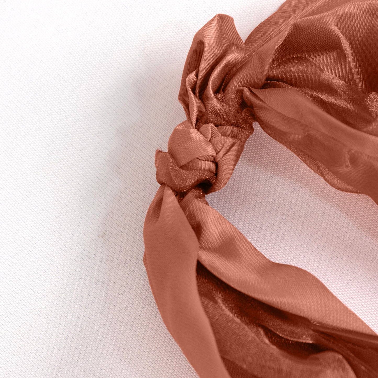 Terracotta chiffon satin chair sash with a curly willow design.